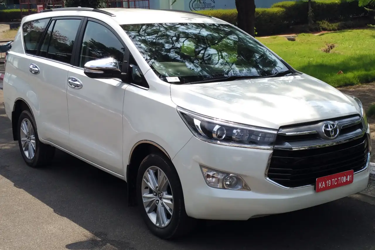 White seven-seater SUV parked by the roadside