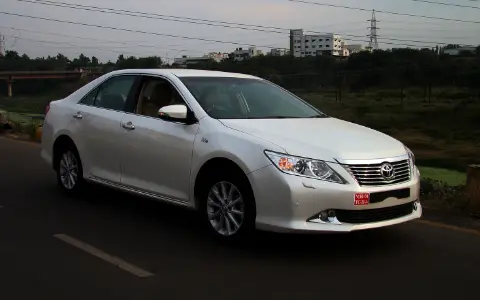 White executive saloon car on a highway